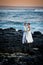 Just Married. Beautiful couple on rocky shore.