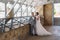 Just married couple of beautiful groom in a gray business suit and a bride in a luxurious white dress with a veil with
