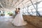Just married couple of beautiful groom in a gray business suit and a bride in a luxurious white dress with a veil with