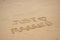 `Just married` message drawn in the sand on the beach with heart on honeymoon