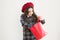 Just a minute of surprise. Little girl looking for surprise gift on yellow background. Small child holding shopping bag