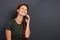 Just one call can make your day. Studio shot of an attractive young red-headed woman using a cellphone.