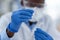 Just one little drop. Closeup of an unrecognizable scientist pouring a substance inside of a test tube to do experiments