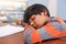 Just a quick nap. a tired elementary school child sleeping on his desk in the classroom.