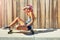 Just a skater having fun. a young woman sitting on her skateboard on a sidewalk.