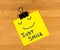 Just smile sticky note on wooden background