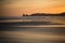 Just before sunrise silhouette of deux jumeaux in summer sky on a sandy beach