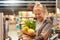 Just walk out shopping technology. Woman at the supermarket standing with shopping in paper bag laughing happy close-up