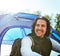 This is just what I needed. a handsome young man sitting at his campsite.