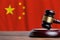 Justice and court concept in People Republic of China. Judge hammer on a flag background