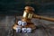 Justice gavel and dice on the background of an old wooden table