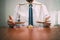 justice and law concept.Male lawyer in the office with brass scale on wooden table,reflected view