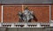 Justice between the Venetian lions on the facade of the tower of St Mark`s bell tower, Venice