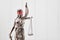 Justitia figure as law concept in front of wood background