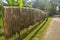 Jute fibers, fabric hanging on long bamboo poles in day light for drying on a village road side, selective focusing