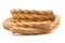 Jute rope with sealed ends rolled in coil on white background