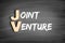 JV - Joint Venture acronym, business concept on blackboard