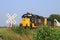 K&O Train hauling Electric Windmill blades with tree`s and blue sky out in the country.