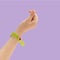 K pop concept. A girl teenager hand showing finger heart gesture. Pvc bracelet suitable for concerts, events or hotel tagging.