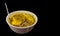 Kaccha aam chutney sweet n sour unripe green mango pickle on a china clay bowl on an isolated black background with copy space for