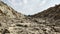 A kaccha valley road of rocky soil in the summer heat