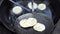 Kachori being fried in a frying pan.