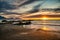 Kaikoura beach during a dramatic colourful sunrise as the sun rises above the horizon over the ocean