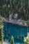 Kaindy Lake in Tien Shan mountains in Kazakhstan in summer with a sunken fir forest. Top view from a drone