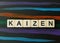 Kaizen word in letters on dark background.