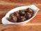 Kala jamun traditional indian dessert,served over a white plate on a rustic wooden background, selective focus