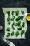 Kale bits on baking paper - preparing kale chips