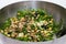 Kale salad in silver salad bowl on white background