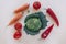 Kale, tomato, carrot and bell peper on beige background. Healthy raw vegan food, diet, detox concept. Top view, flat lay