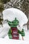 Kali the Ramsaurier, likeable, snow covered, green dinosaur mascot of ski school at ski region Ramsau Dachstein, Steiermark.