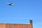 KALININGRAD REGION, RUSSIA. The plane of Uzbekistan Airways is flying over the fortress wall with a nest of storks. Schaaken Castl