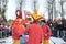 KALININGRAD, RUSSIA. Buffoons stand against the background of an effigy. The celebration of Maslenitsa in the park