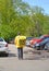 KALININGRAD, RUSSIA. The courier of the fast food delivery service  `Yandex Eda` goes to the car parking lot. Russian text