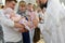 KALININGRAD, RUSSIA. Eel anointing the baby `s legs after immersion in water. Baptism rite