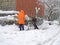 KALININGRAD, RUSSIA. Teenager helps janitor remove snow during snowfall