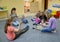 KALININGRAD, RUSSIA. The tutor conducts occupation with small children and their parents in studio of creative development