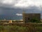KALKARA, MALTA - Apr 18, 2014: Country side church and cruise-liner approaching the Grand Harbour in Malta, on stormy cloudy day
