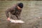 Kalum River, British Columbia, Canada - April 11th, 2017: An angler releasing a steelhead back into a river in British Columbia