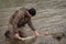 Kalum River, British Columbia, Canada - April 11th, 2017: An angler unhooking a fly from a steelhead in the morning spring sun