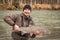 Kalum River, British Columbia, Canada - April 11th, 2017: A fisherman holding up a steelhead, from a river in British Columbia