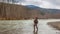 Kalum River, British Columbia, Canada - April 11th, 2017:A fly fisherman hooked into a big fish in a river with the rod bent