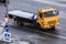 KamAZ 4308 flatbed tow truck moving on the street, aerial front side view