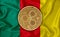 Kamerun flag, ripple gold coin on flag background. The concept of blockchain, bitcoin, currency decentralization in the country.