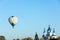 KAMIANETS-PODILSKYI, UKRAINE - OCTOBER 06, 2018: Beautiful view of hot air balloon flying near Saint George`s Cathedral. Space fo