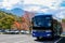 Kamikochi, Nagano, Japan - October 2022 : Unidentified tourists bus with a beautiful background of Fall foliage season in Japan al