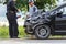 KAMPHAENG PHET, THAILAND - JULY 17 : An unidentified people checking front of black car which got damaged by accident on the road